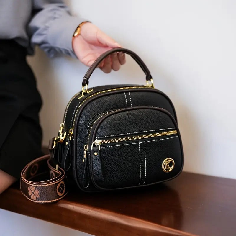 Bolso bandolera premium en sintético tipo cuero con cremallera y correa ajustable. Elegante, práctico e ideal para uso diario en Colombia.