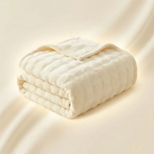 Cobija suave tipo piel de conejo con textura piña, térmica y confortable, ideal para un descanso cálido y acogedor.