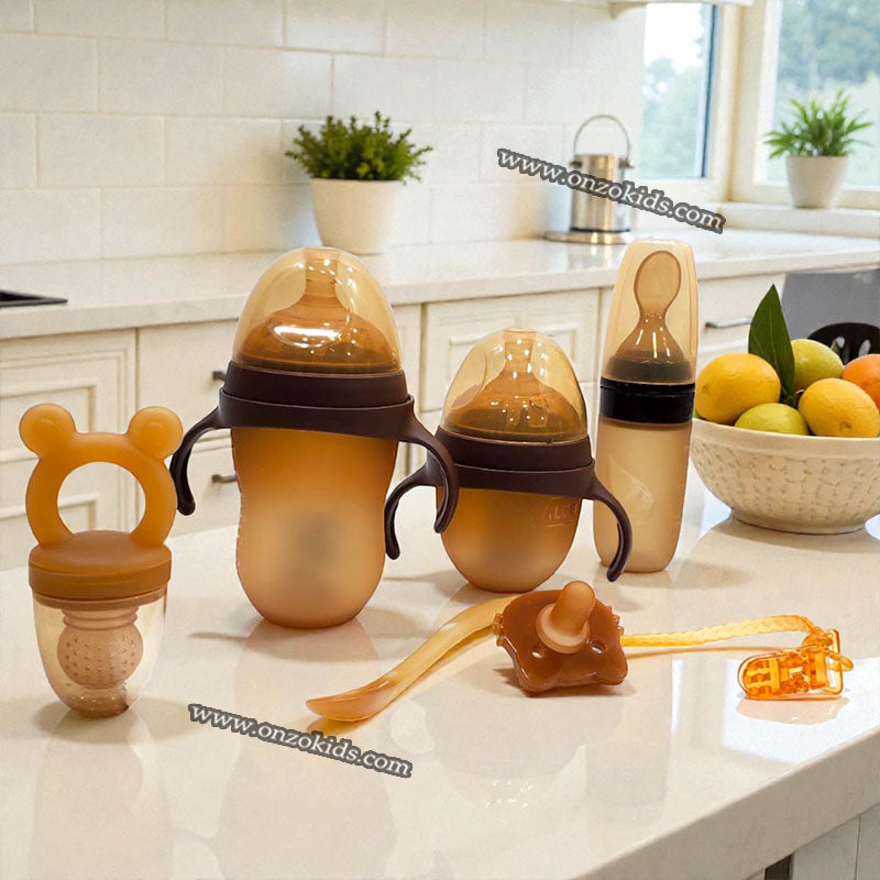 Kit de alimentación para bebé en silicona libre de BPA con biberones, cuchara y accesorios. Ideal para destete, primeros alimentos y desarrollo de autonomía.