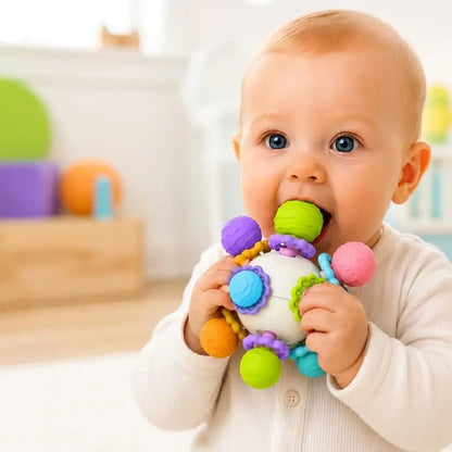 Sonajero mordedor sensorial para bebé desde 3 meses, con silicona texturizada, colores llamativos y sonido suave para acompañar la dentición y el juego sensorial.